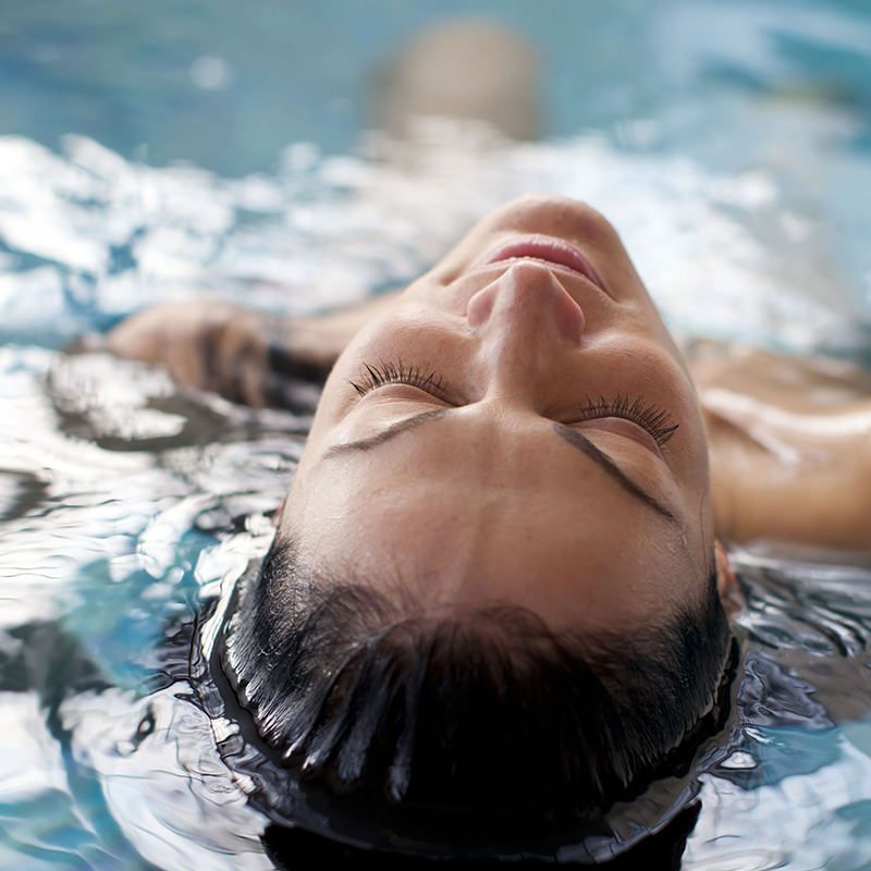 Person Laying in a Pool Person Laying in a Pool